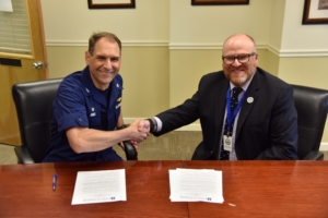 Coast Guard and LSSU leaders sign the tuition agreement