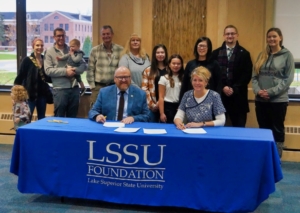 Stakeholders gather to sign the Korson Chippewa County Sunrise Rotary Club Award scholarship.