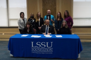 Stakeholders gather to sign the Heidi Bailey Memorial Nursing Scholarship.