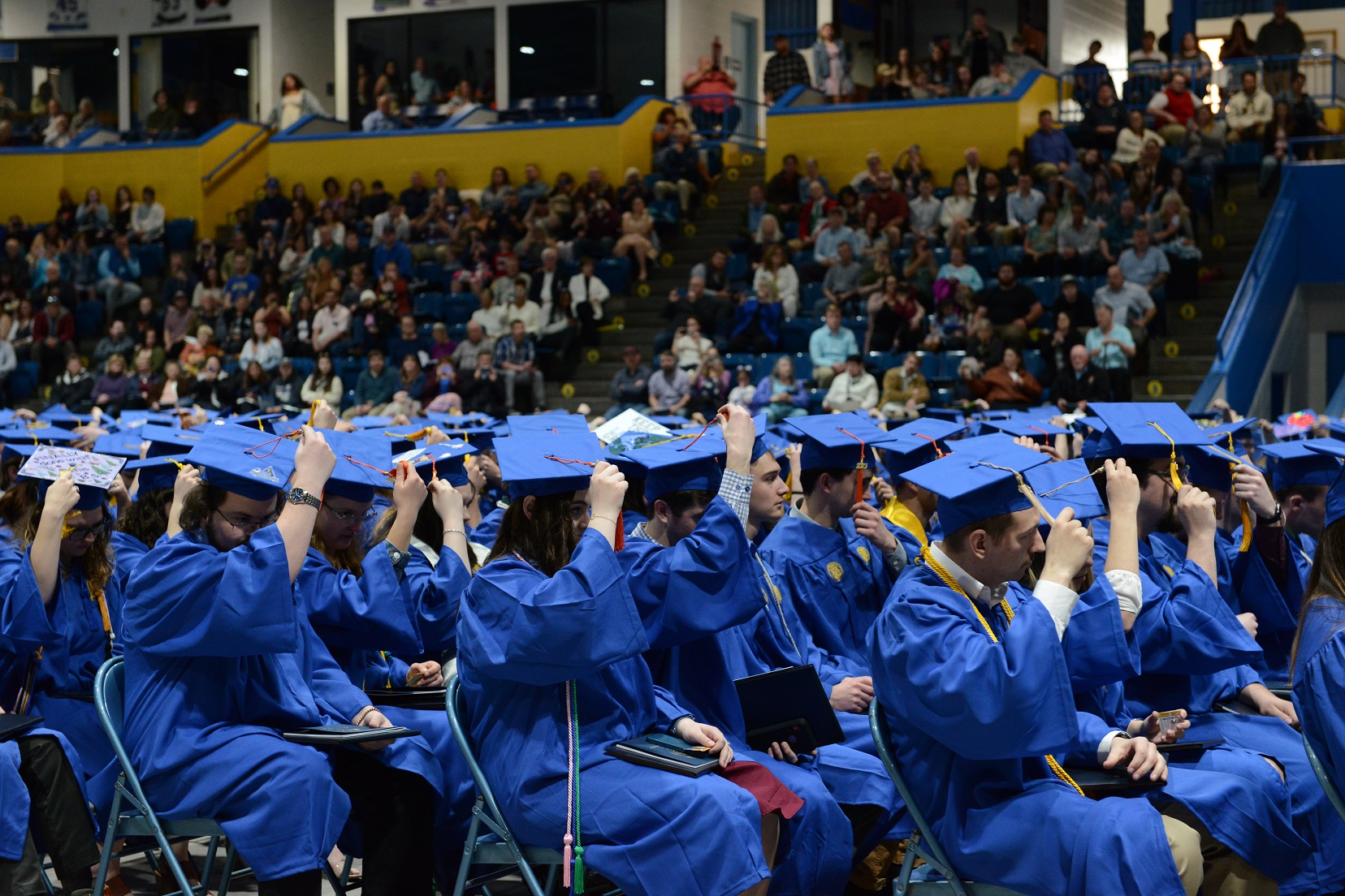 Graduates move their tassels at commencement.